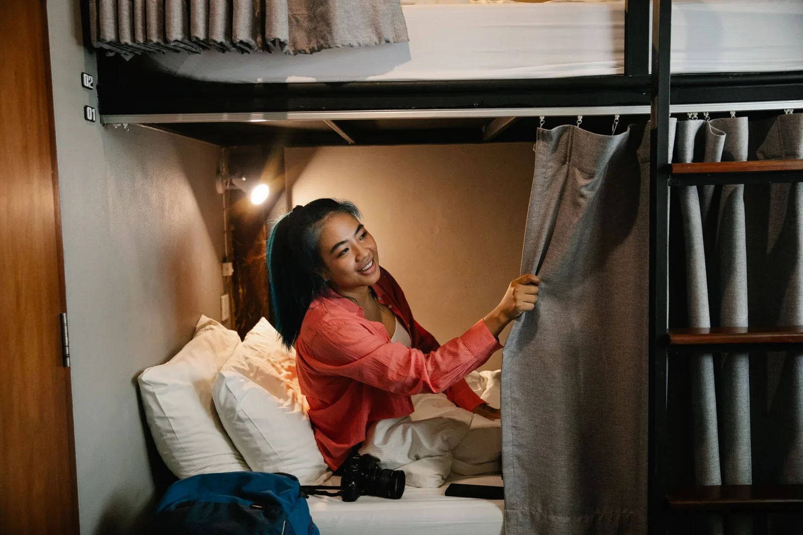 Two travelers comparing a hostel dorm bed against an Airbnb apartment cost